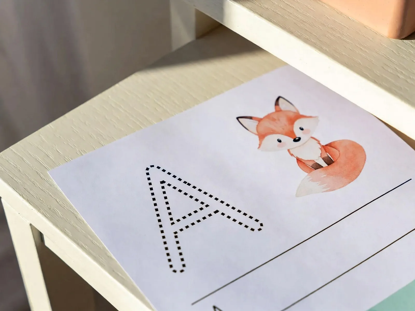 Alphabet tracing worksheet with a dotted letter A and a watercolor fox
